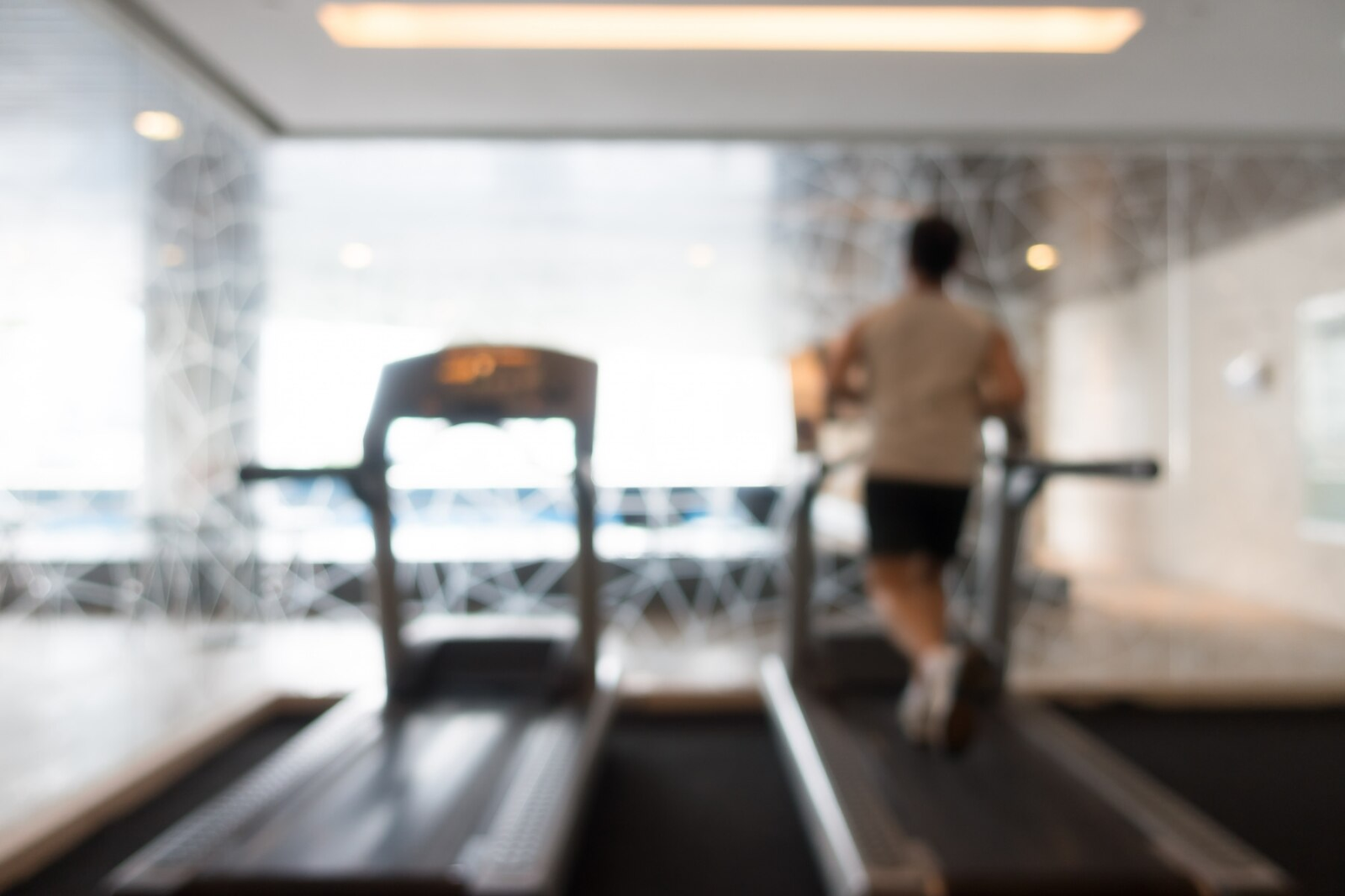 an image of a blurred photo of a person running on a treadmill